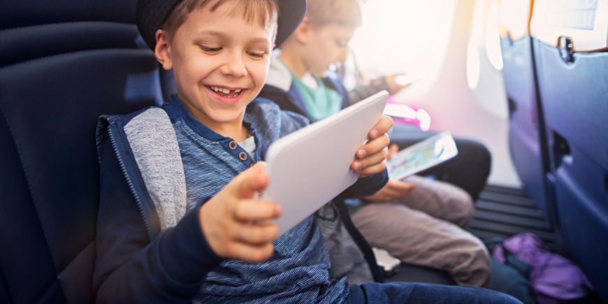 Children playing with iPad on the plane