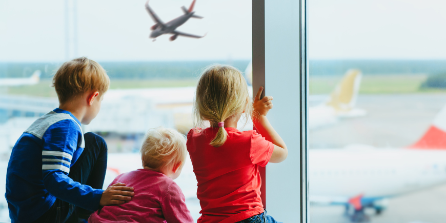 Three children waiting at the airport