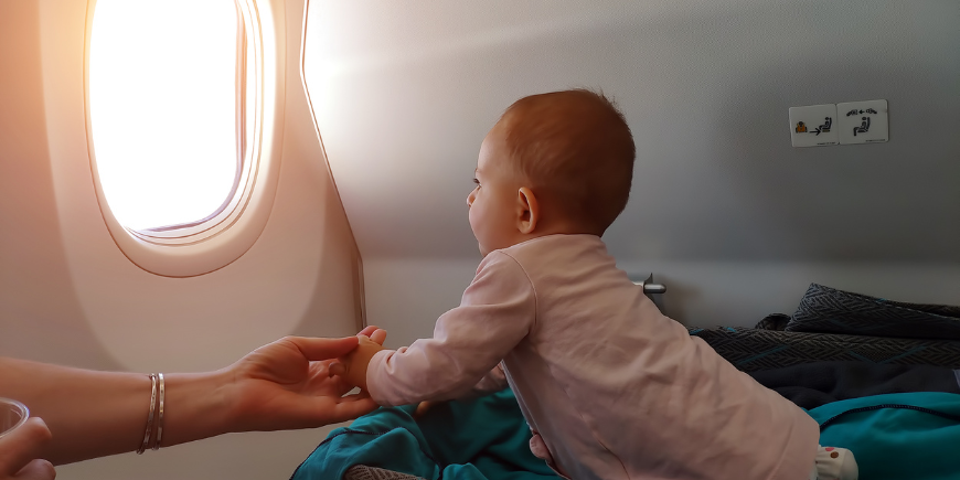 Little baby looking out the aeroplane window