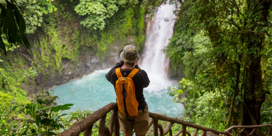 Photographer in front of a waterfall in Costa Rica