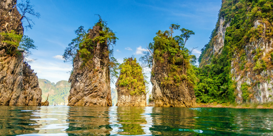 Beautiful mountains lake river sky and natural attractions in Ratchaprapha Dam at Khao Sok National Park, Surat Thani Province, Thailand.