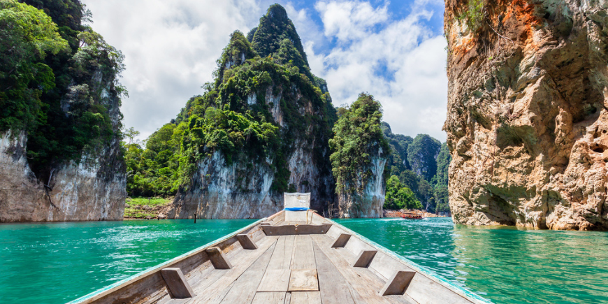 Traditional longtail boat with beautiful scenery view in Ratchaprapha Dam at Khao Sok National Park, Surat Thani Province, Thailand.