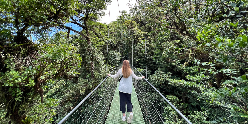 Woman standing on hanging bridge in Monteverde, Costa Rica