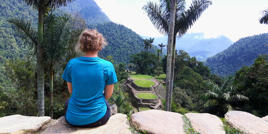 Woman sitting looking at La Ciudad Perdida in Columbia