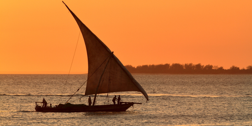 Traditional dhow sailboat at sunset in Zanzibar, Tanzania