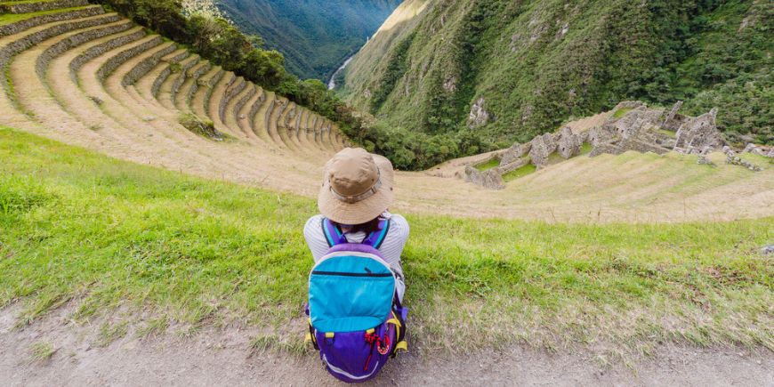 Woman sitting on terraced mountainside on Inca Trail