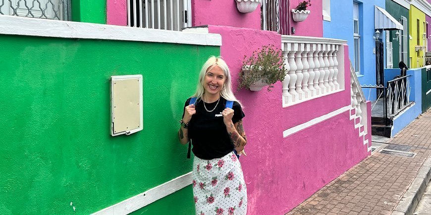 Catriona stands in front of the colourful houses in Bo-Kaap in Cape Town