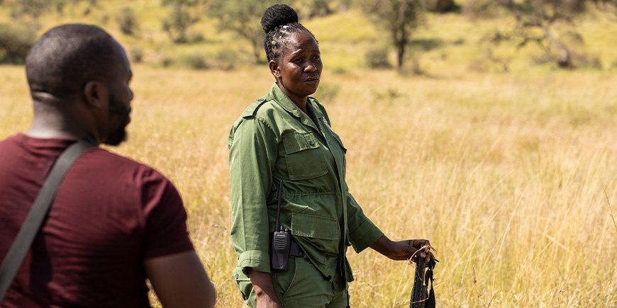 Woman with rifle on the savannah