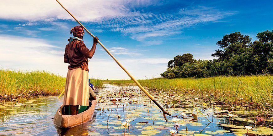 Woman sailing in a boat in the Okavango Delta in Botswana