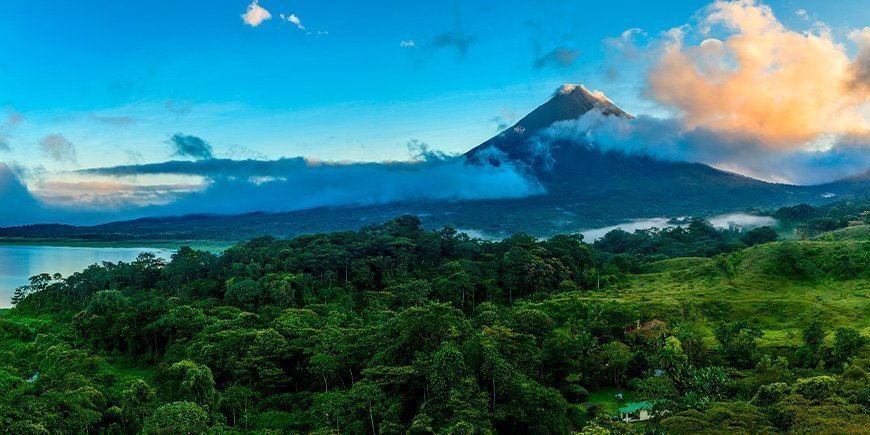 View of the Arenal Volcano under blue skies in Costa Rica