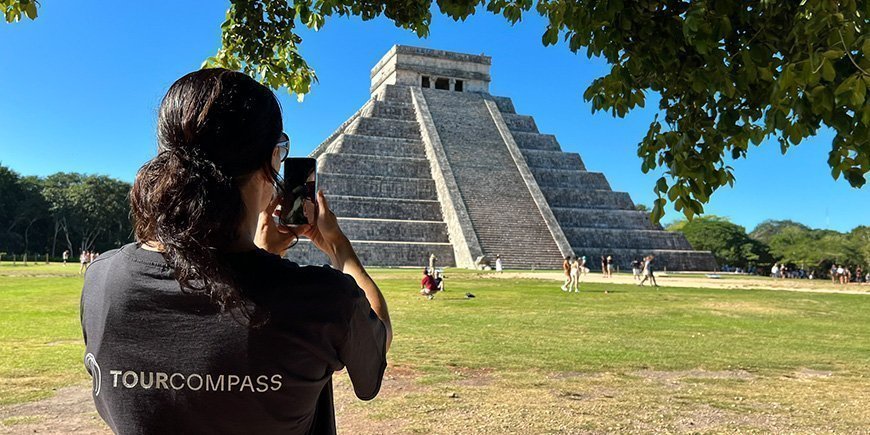 TourCmpass team member takes a photo of Chichen Itza in Mexico.