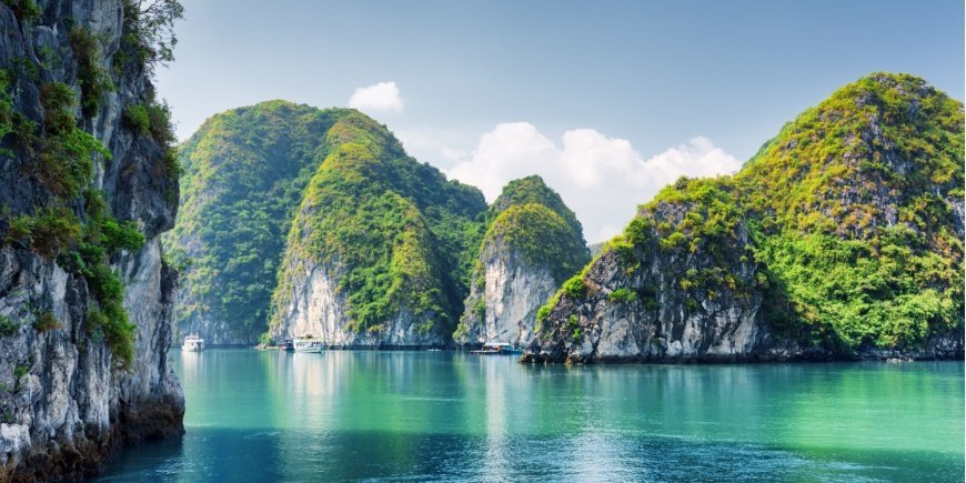 Limestone formations in jade green water in Ha Long Bay