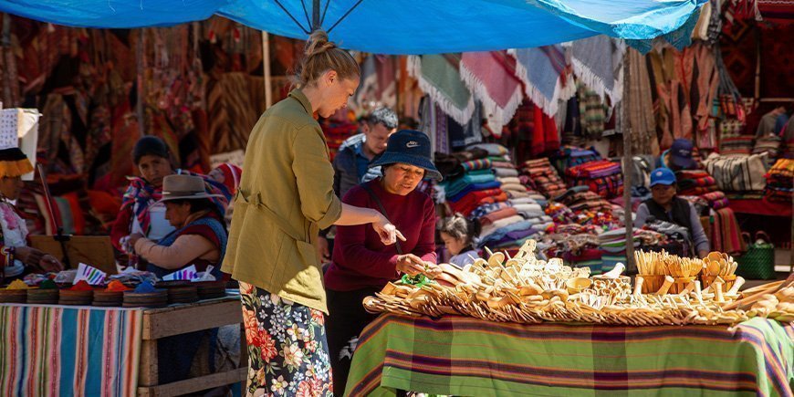 Woman buying local souvenirs in Cusco, Peru