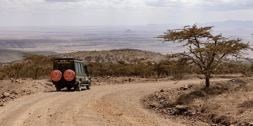 Four-wheel drive vehicle with TourCompass logo goes on safari in Tanzania