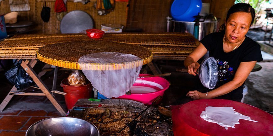 Vietnamese women making rice paper in Vietnam