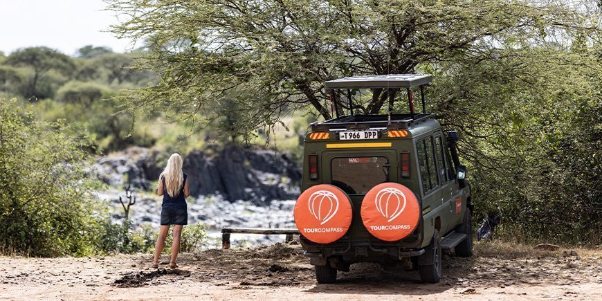 Woman and TourCompass Jeep in Tanzania