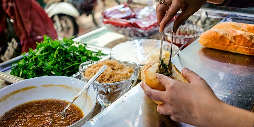 Woman making a Banh Mi sandwich in Ho Chi Minh City, Vietnam