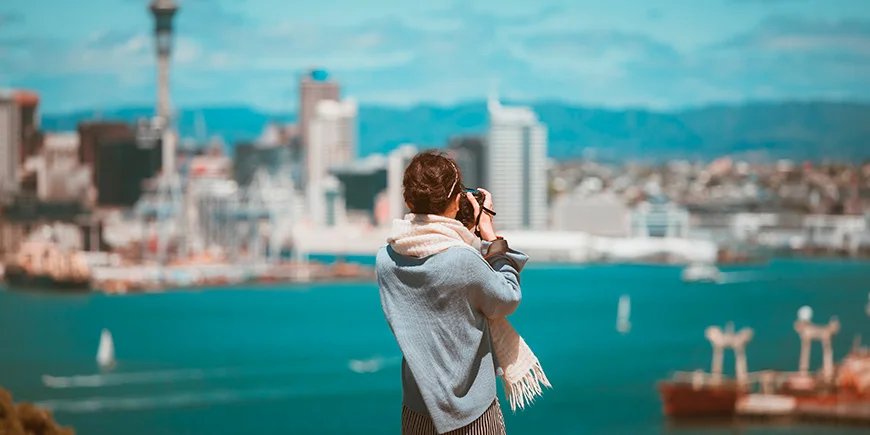Woman taking photographs in Auckland