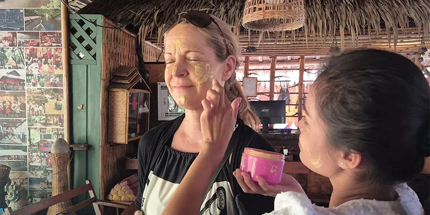 Britta getting her face painted by a local
