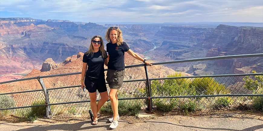 Two women standing at a viewpoint at the Grand Canyon in the United States