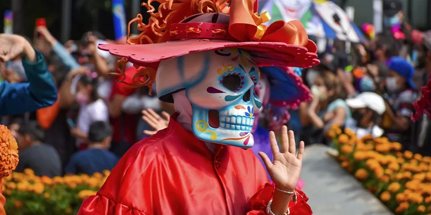 Person in costume during the Day of the Dead parade in Mexico City