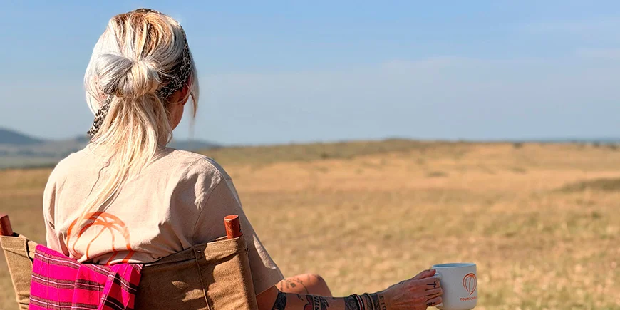 Cat drinking coffee on the savannah in Kenya
