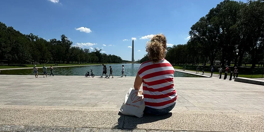 Bianca sitting in front of the Washington Monument in Washington D.C.