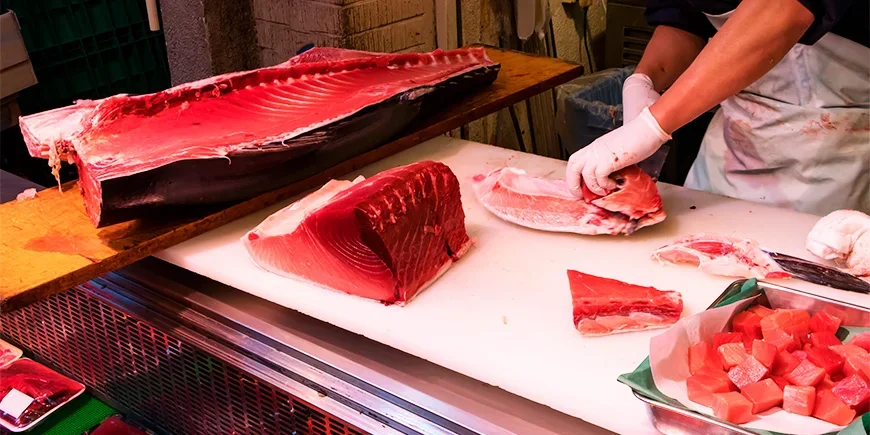 Tuna being sliced at the Tsukiji fish market in Tokyo