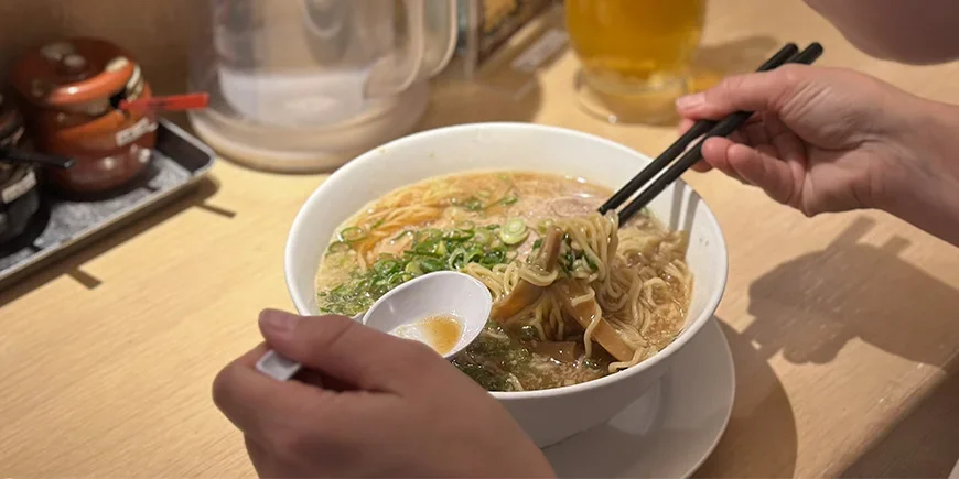 Woman eating ramen in Japan