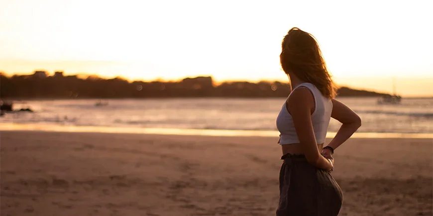 Woman enjoying the sunset on Tamarindo Beach in Costa Rica