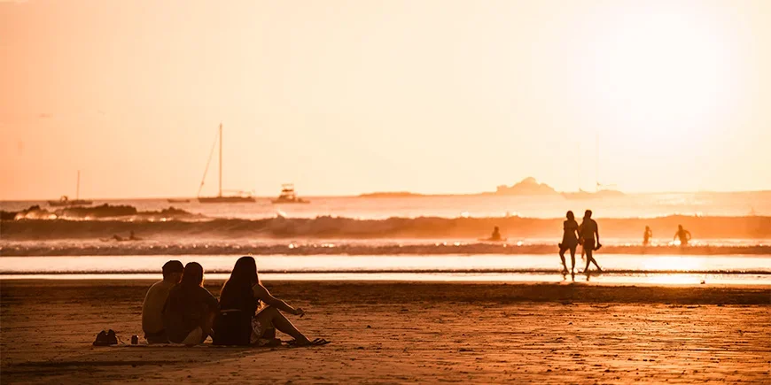 People enjoying the sunset on Tamarindo Beach in Costa Rica