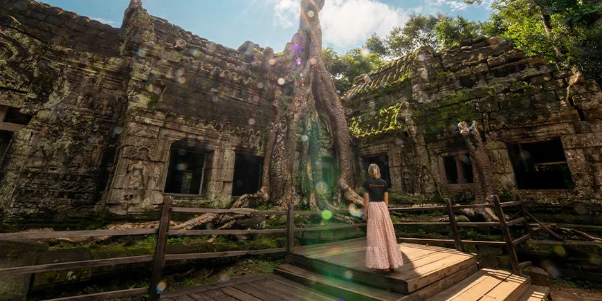 Woman in a TourCompass T-shirt standing in Angkor, Cambodia