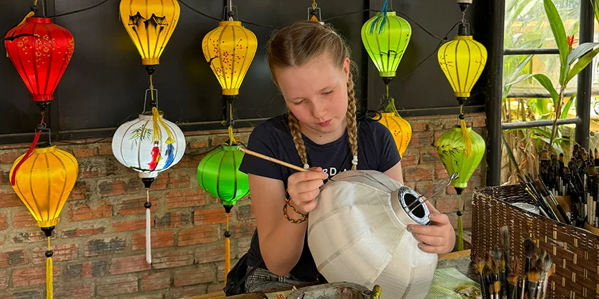 A girl painting lanterns in Hoi An, Vietnam