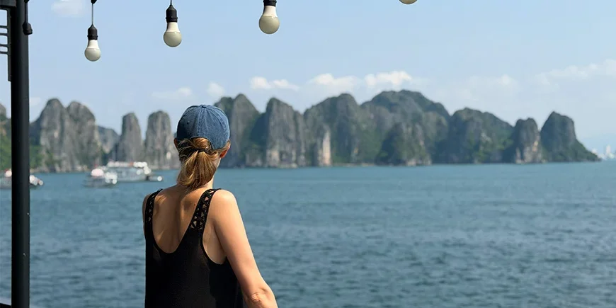 Iida from TourCompass admiring the limestone cliffs of Ha Long Bay