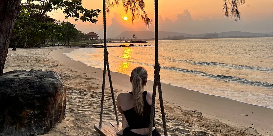 Girl on a swing at sunset on the beach on Phu Quoc