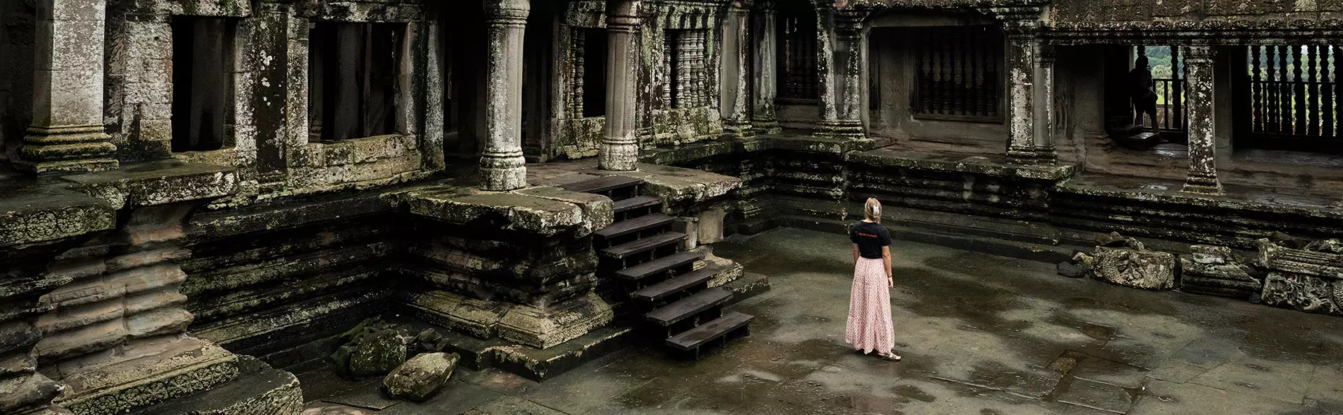 Woman in TourCompass t-shirt exploring the Angkor ruins