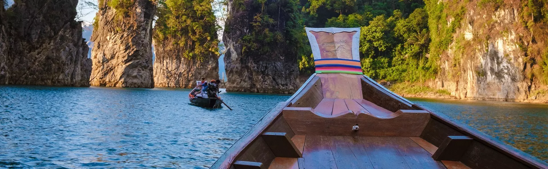 Longtail boat sailing on Cheow Lan Lake in Khao Sok
