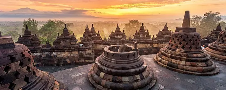 Dramatic and colourful sunrise seen from Borobudur, Java