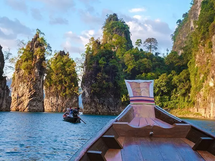 Longtail boat sailing on Cheow Lan Lake in Khao Sok