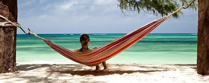 Woman lying in a hammock on a beach in Zanzibar