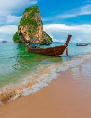 Longtail boats under blue skies at the beach in Krabi, Thailand