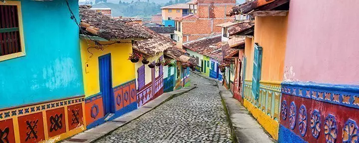 Colourful colonial houses on a cobbled street in Guatape, Antioquia in Colombia