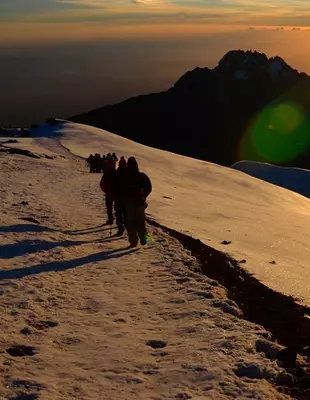 Trekkers in the sunrise on top of Kilimanjaro