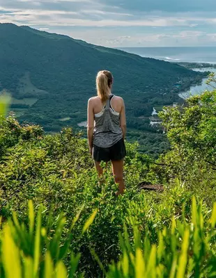 Woman trekking in the lush surroundings of Le Morne in Mauritius
